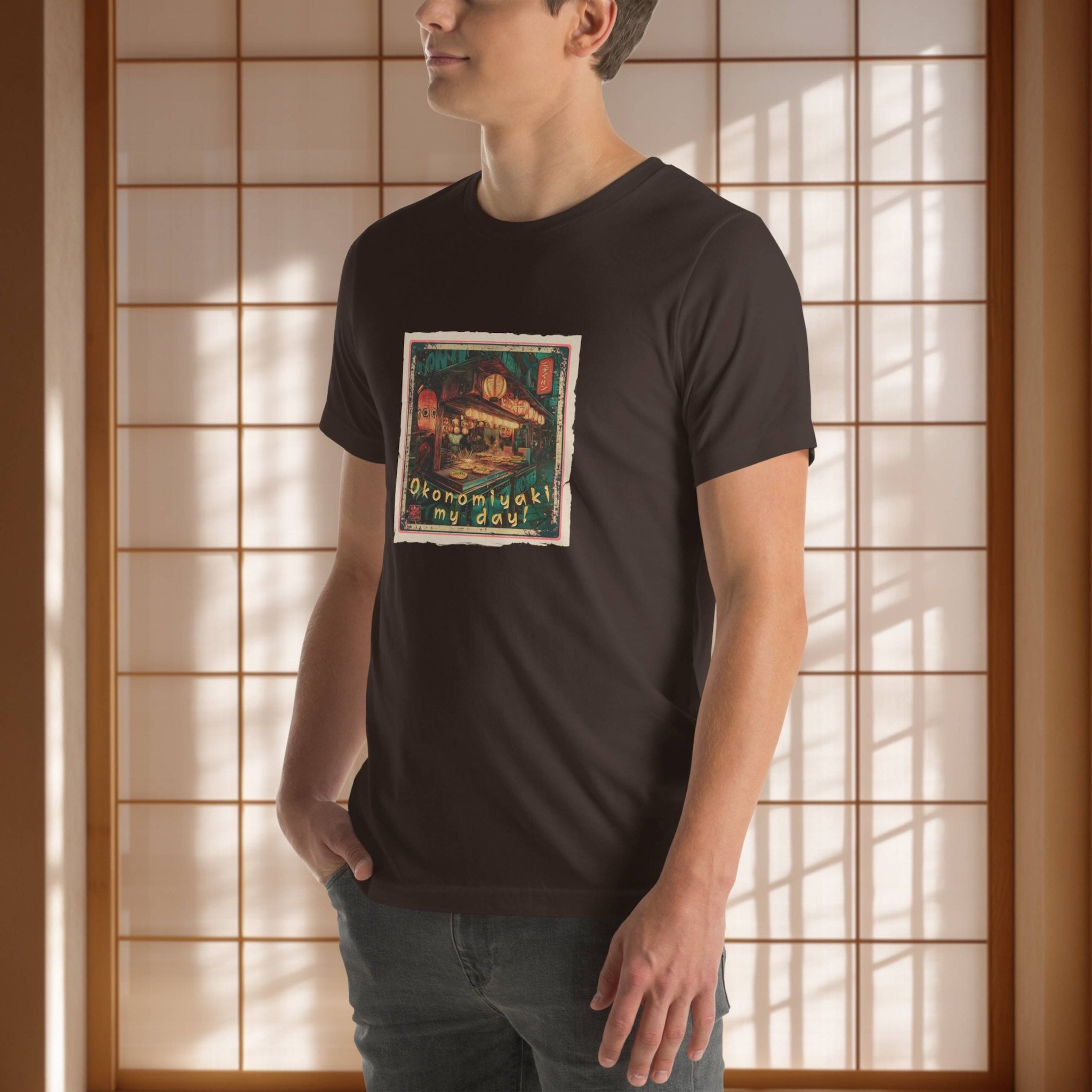 Person wearing a black t-shirt with a japanese graphic design in front of a wooden panel background