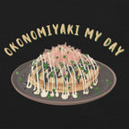 Illustration of okonomiyaki with a text 'OKONOMIYAKI MY DAY' on a black T-shirt background