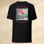 Black t-shirt with monkeys in onsen graphic design and text on the back against a beige background
