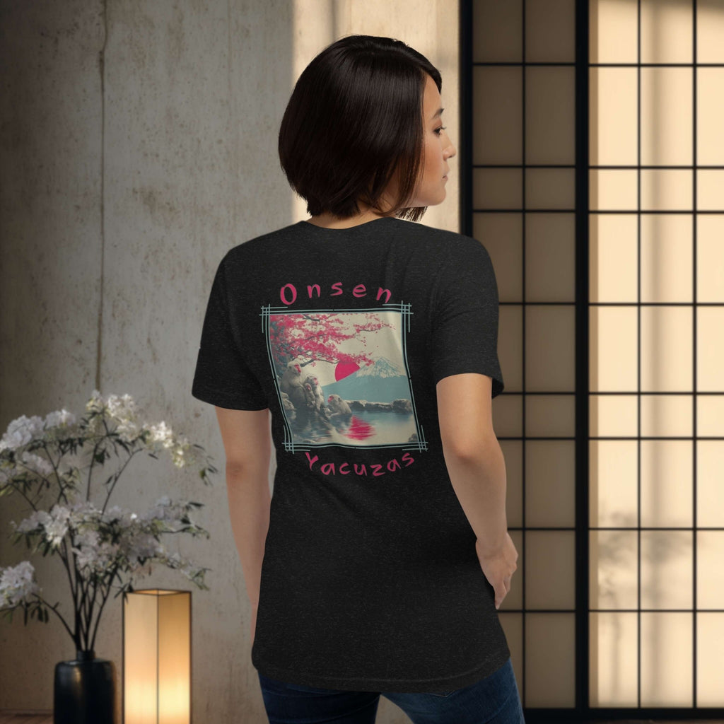 Woman wearing a black t-shirt with 'Onsen Yacuzas' design with japanese snow monkey, standing in a room with a lamp and flowers.