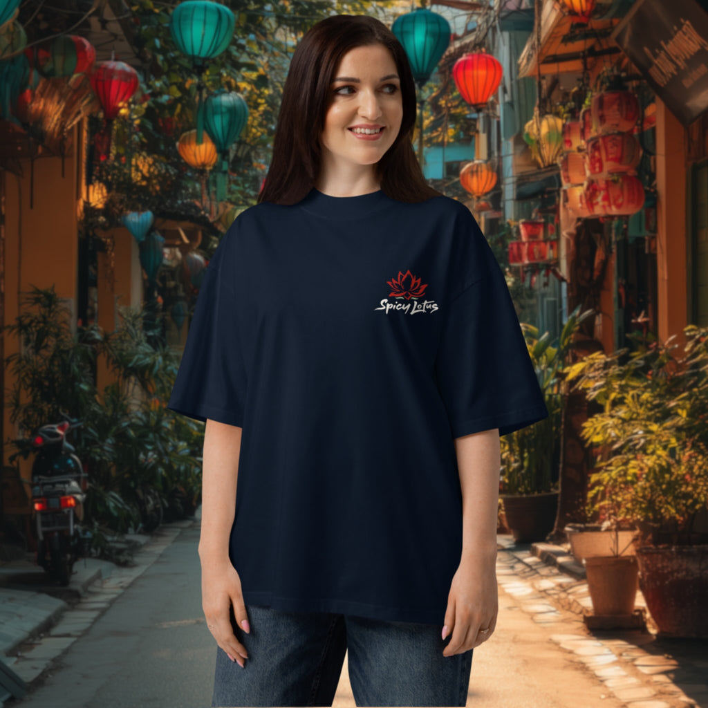 Woman wearing a black oversized What the Pho tee  with a chest  logo in an outdoor setting with colorful lanterns in Hoi An, Vietnam