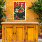 Vintage-style poster of Pho on a yellow wall above a wooden cabinet with plants around.