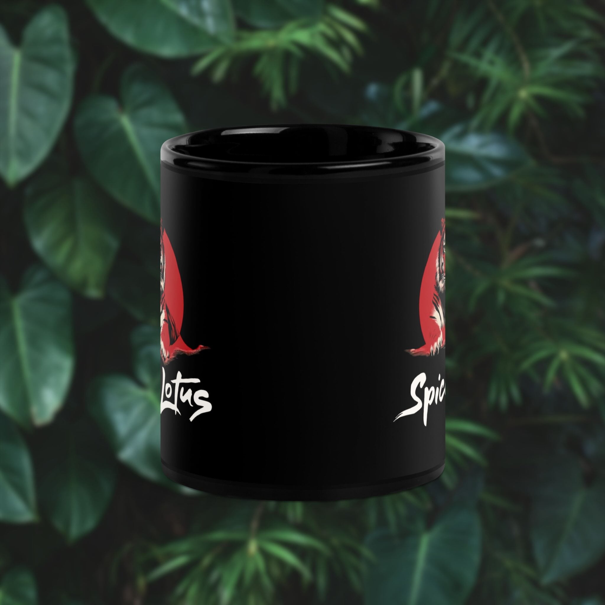 Black mug with red tiger design and text on a green leafy background