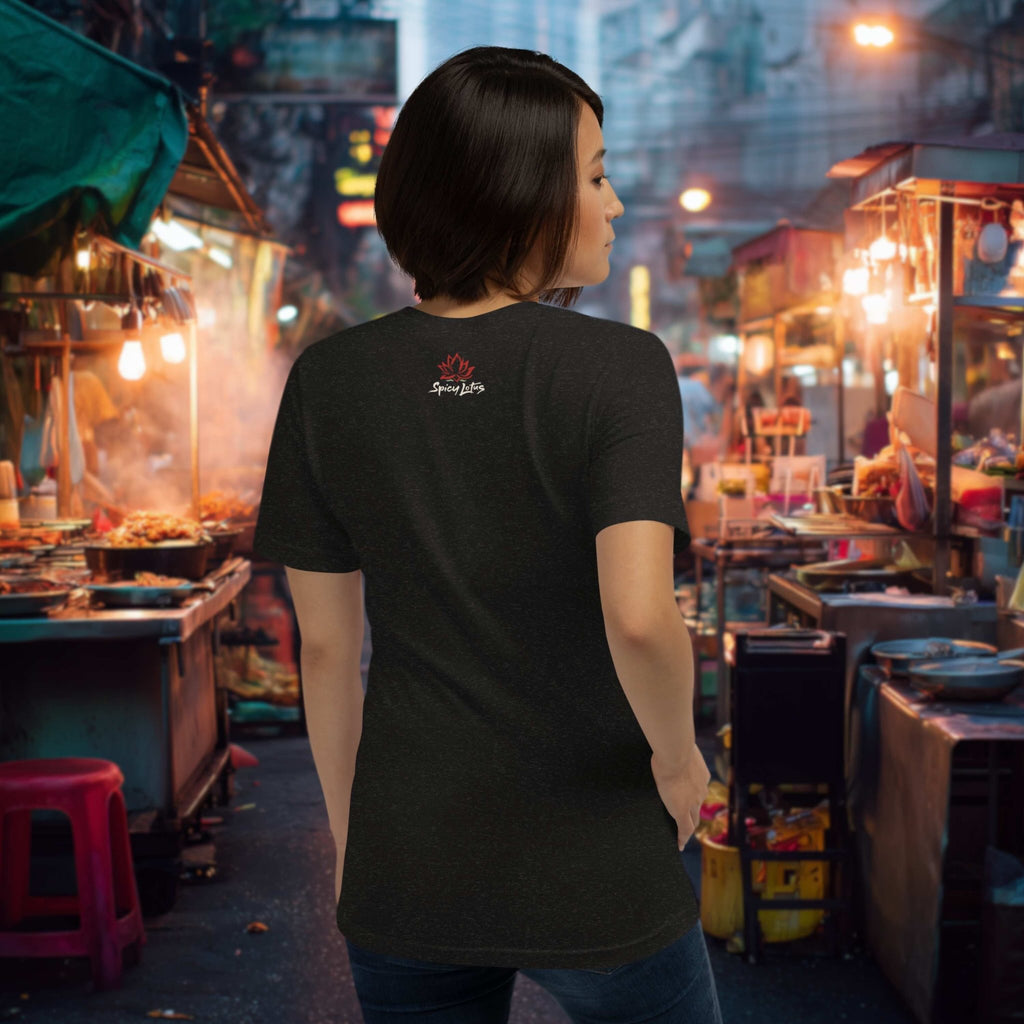 Woman in a black t-shirt with a logo standing in a bustling asian night market.