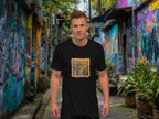 Man wearing a black t-shirt with a graphic design of a balinese monkey 'monkey business' in a colorful alleyway.