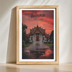 Reflective stone pathway and glowing temple architecture of Wat Benchamabophit in wooden frame