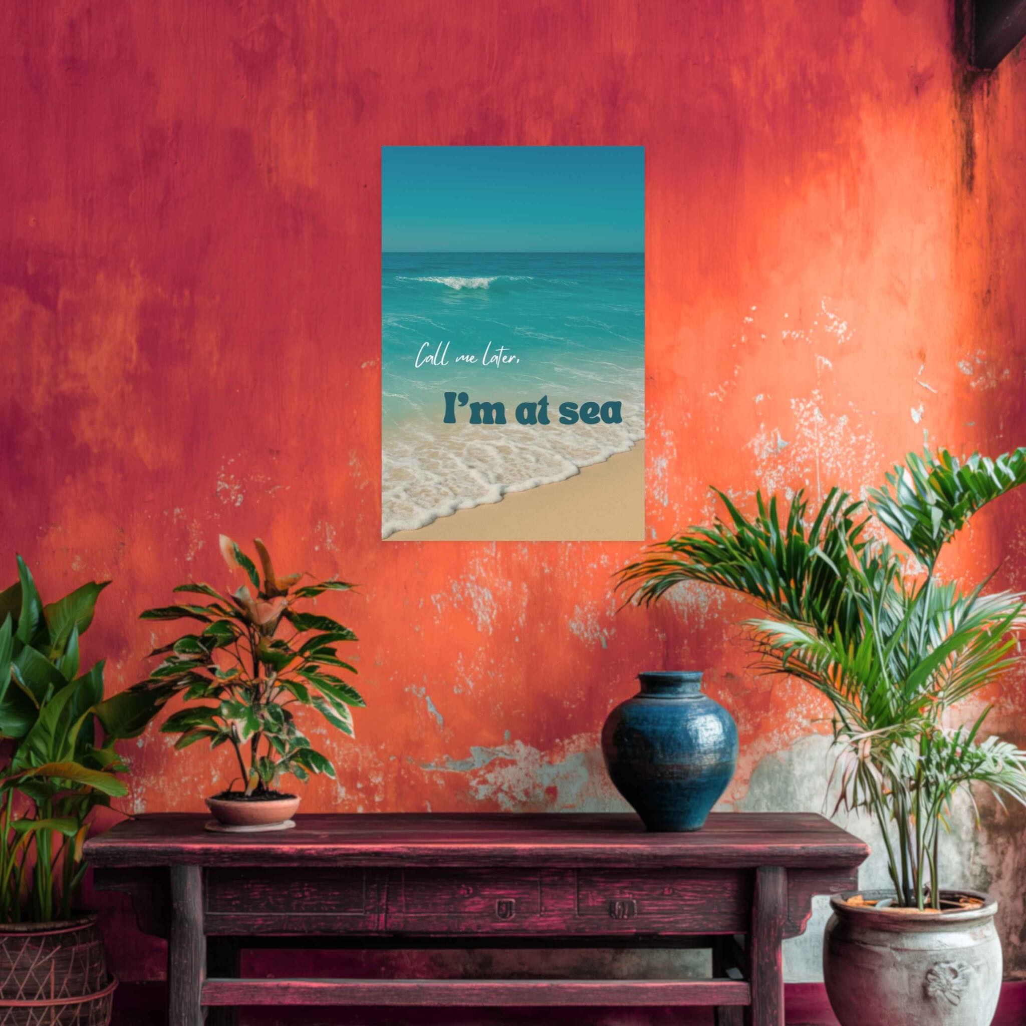 Decorative setup with a painting of a beach scene on an orange wall, plants, and a vase.