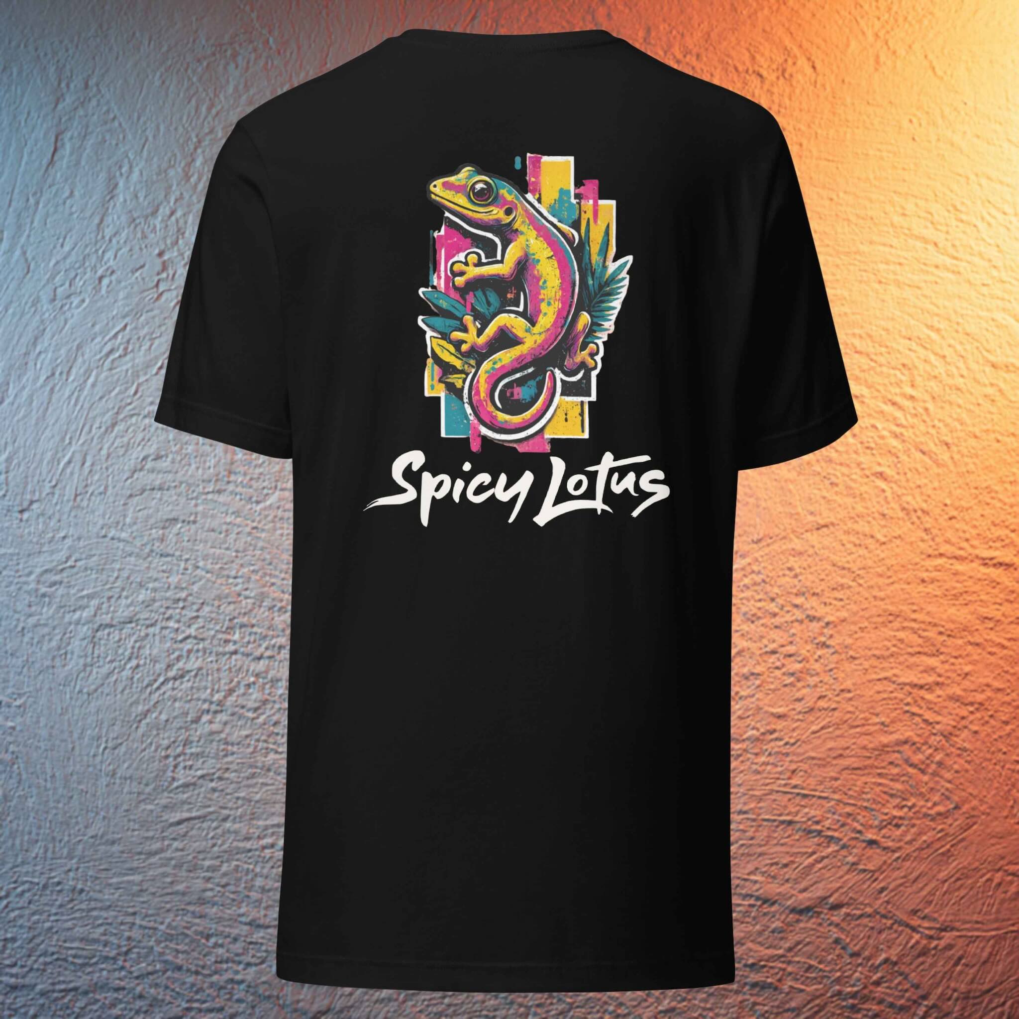 Black t-shirt with colorful gecko design and 'Spicy Lotus' text on a textured wall background