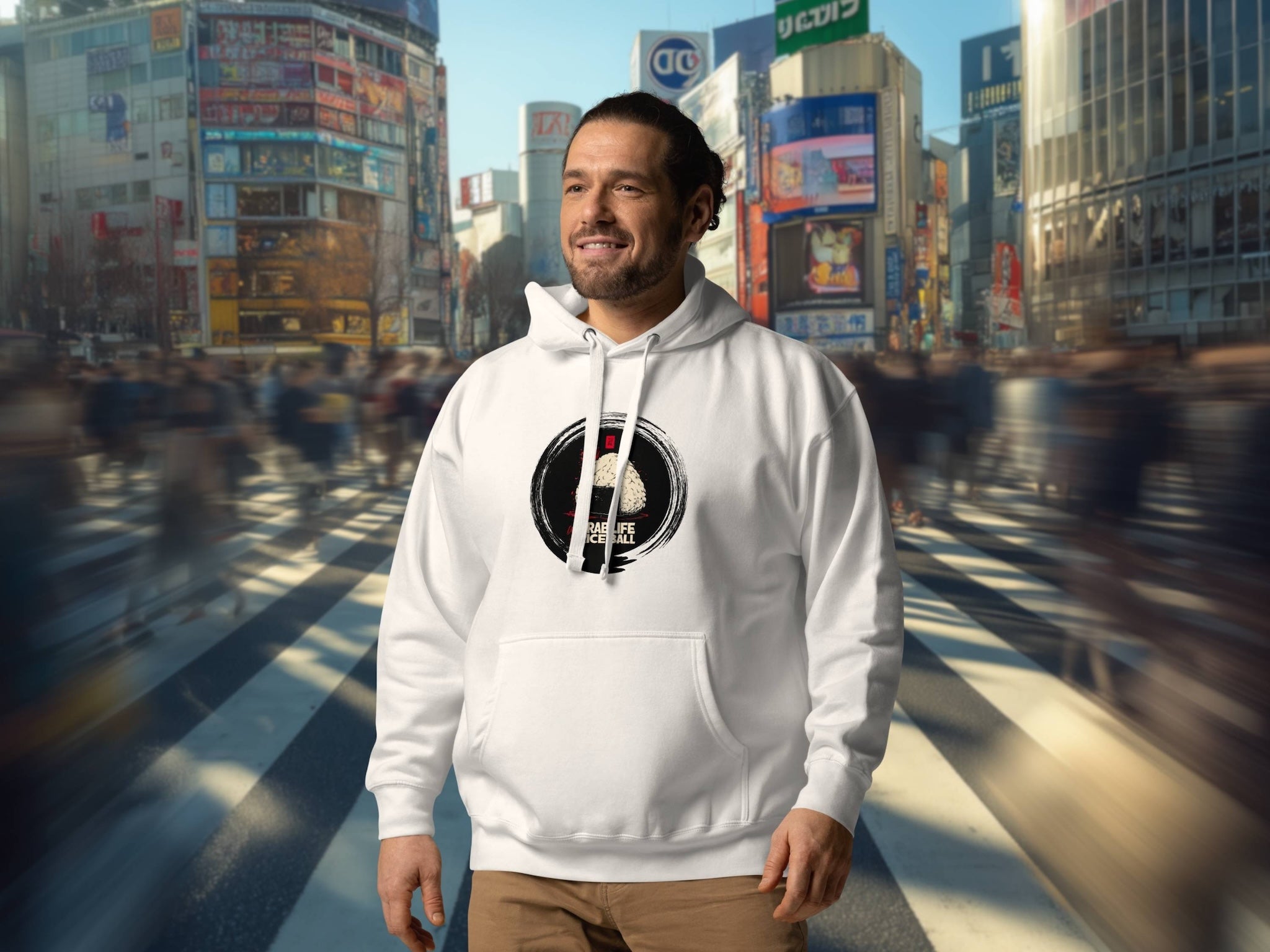 Man wearing a white hoodie with a japanese onigiri graphic at Shibuya crossing in Tokio