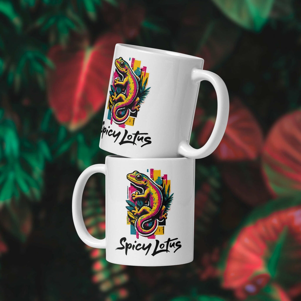 Two white 11 oz mugs with a colorful gecko design and 'Spicy Lotus' text on a leafy background.