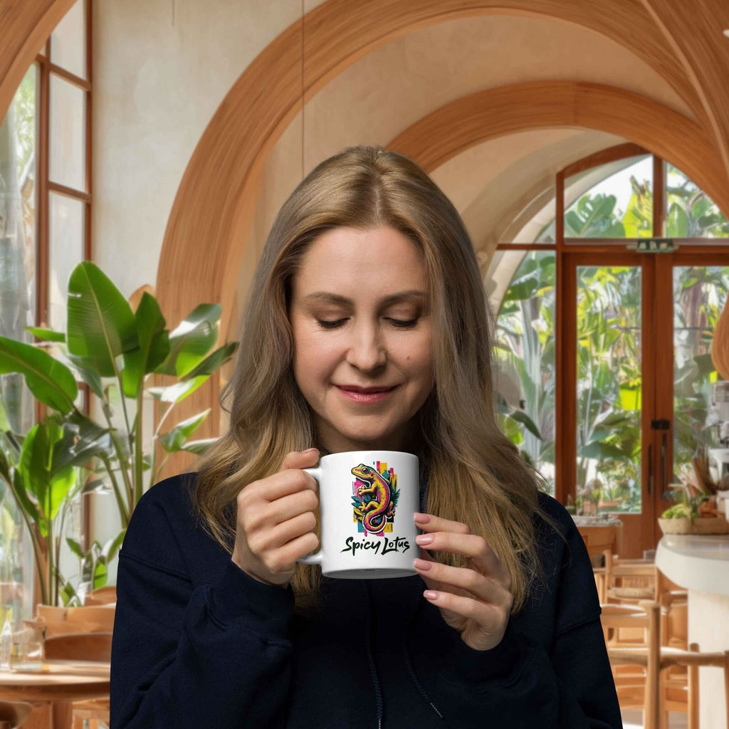 Woman holding a mug with a colorful gecko design in a cafe setting