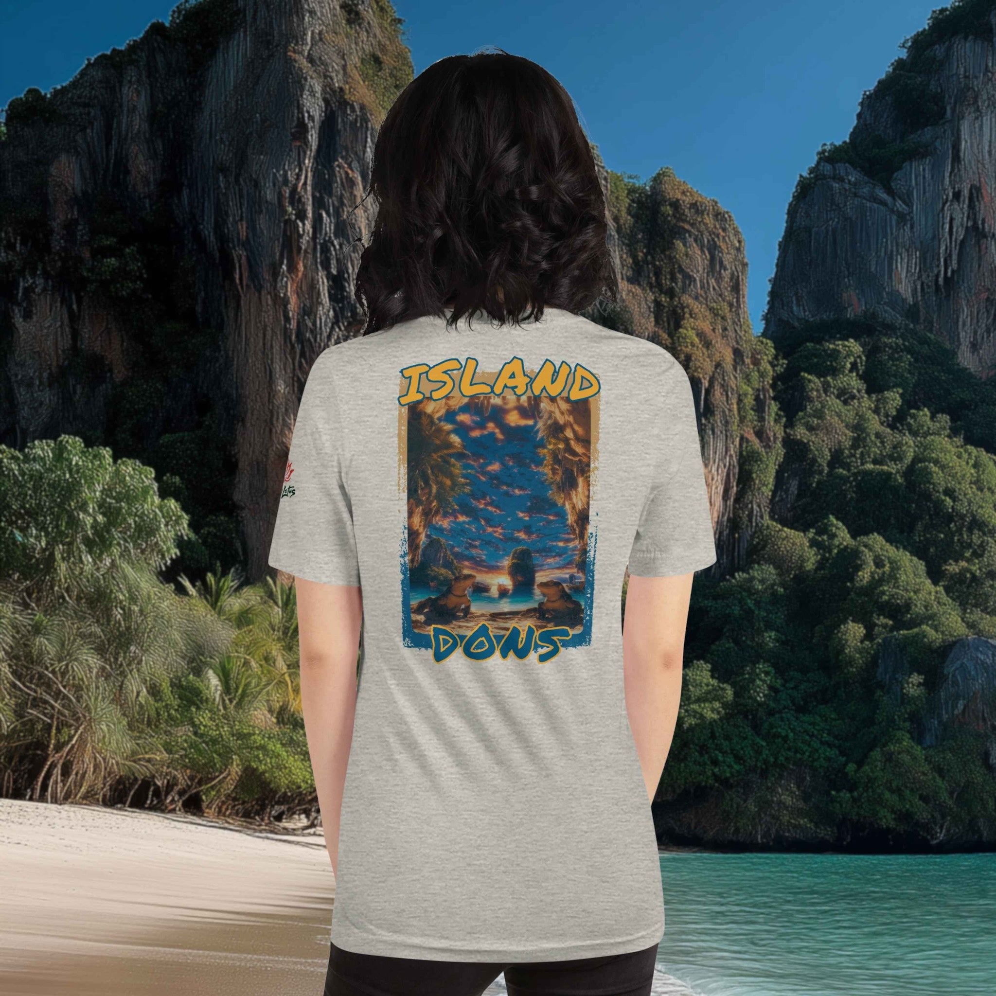 Person wearing a t-shirt with 'Island Dons' design in a scenic beach location.