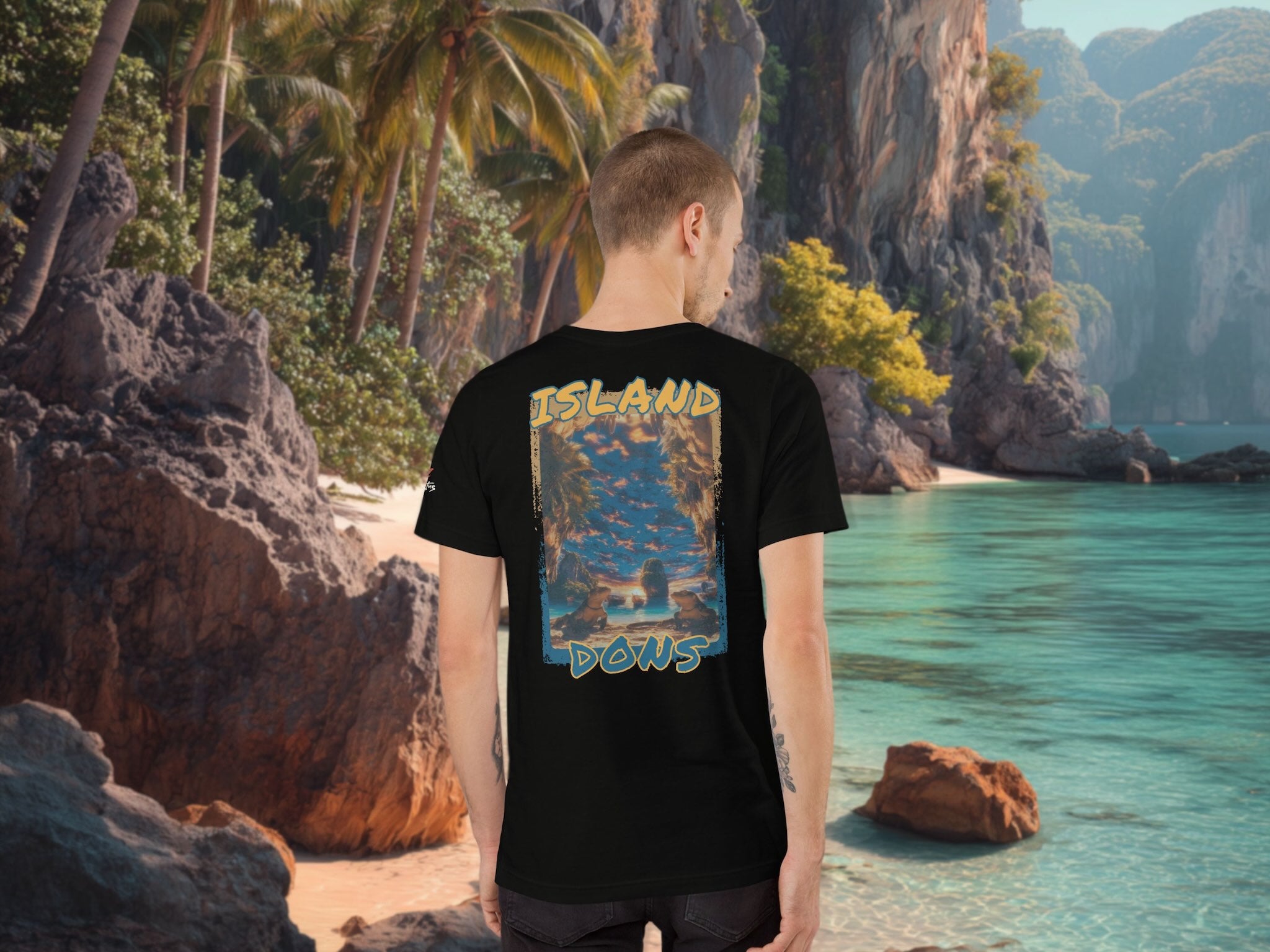 Person wearing a black t-shirt with 'Island Dons' graphic design in a tropical setting.