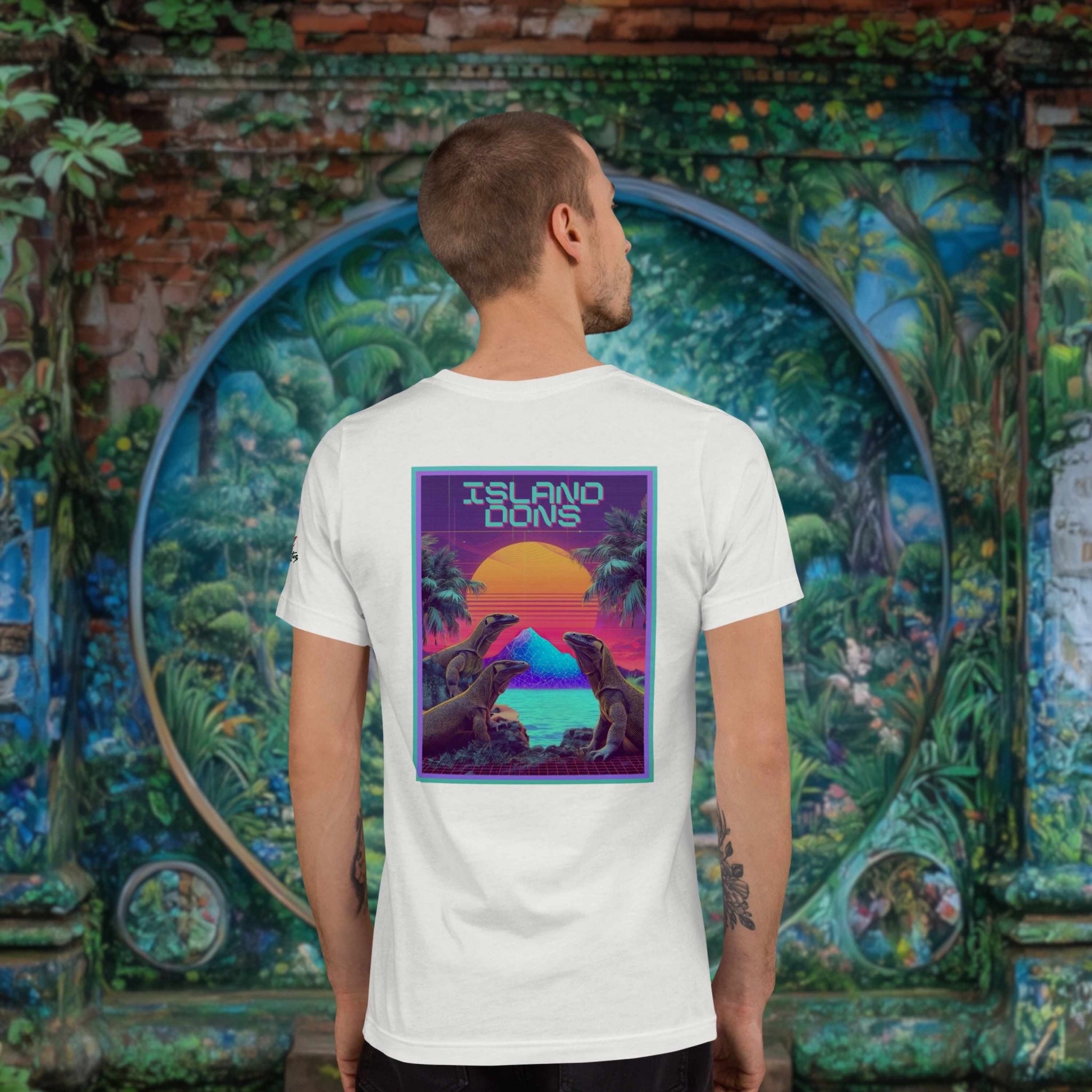 Island Dons Komodo Nights back print t-shirt on a young man in front of painted wall