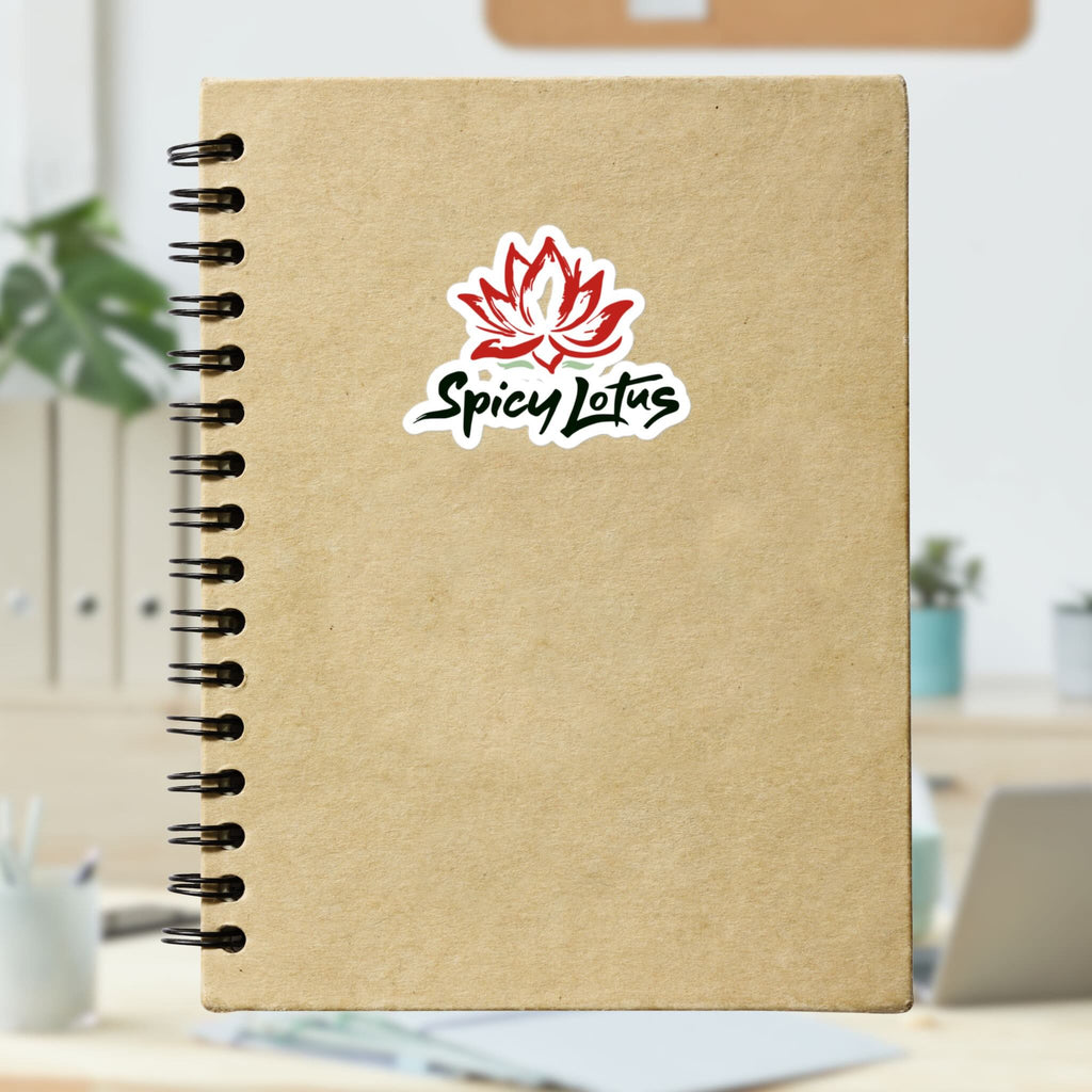 Brown notebook with Spicy Lotus logo kiss cut sticker with lotus flower on a blurred indoor background
