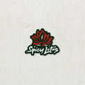 Spicy Lotus logo, red lotus flower with green sticker frame and white font on a textured white background