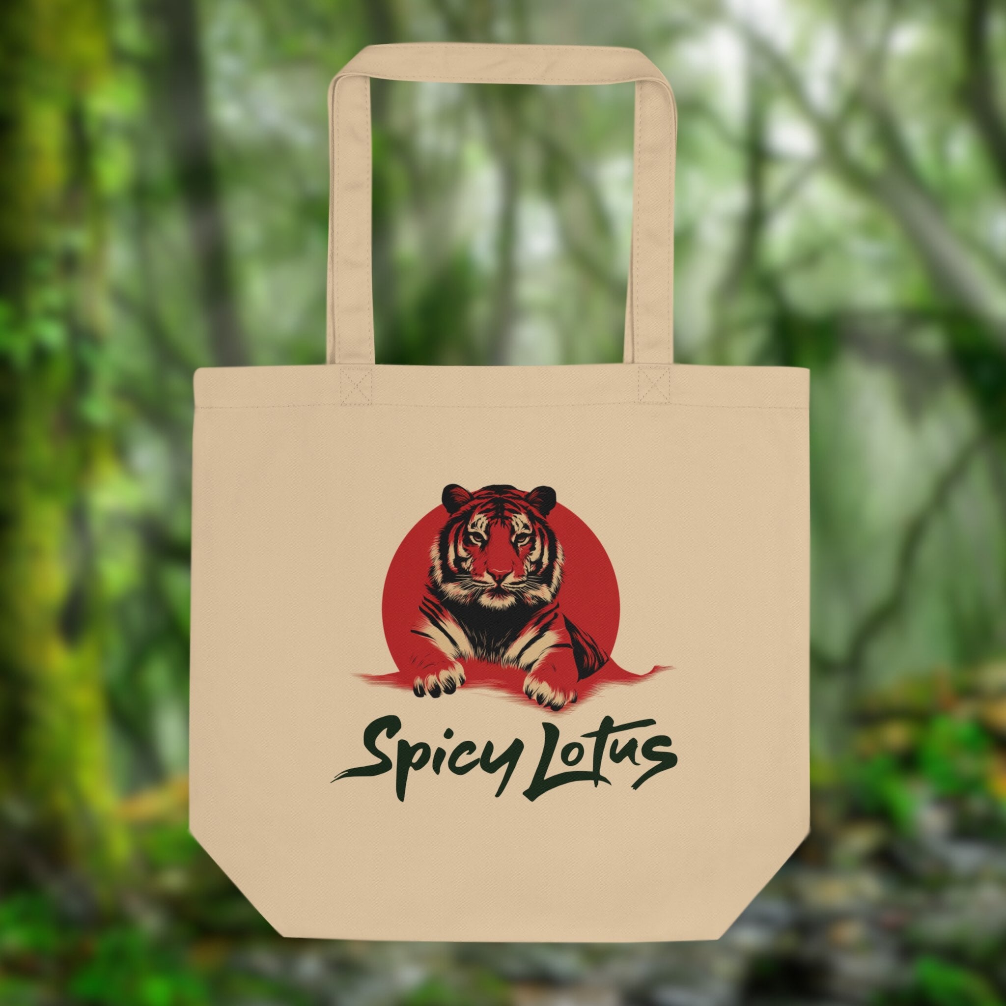Beige tote bag with a tiger design and 'Spicy Lotus' text against a blurred green forest background