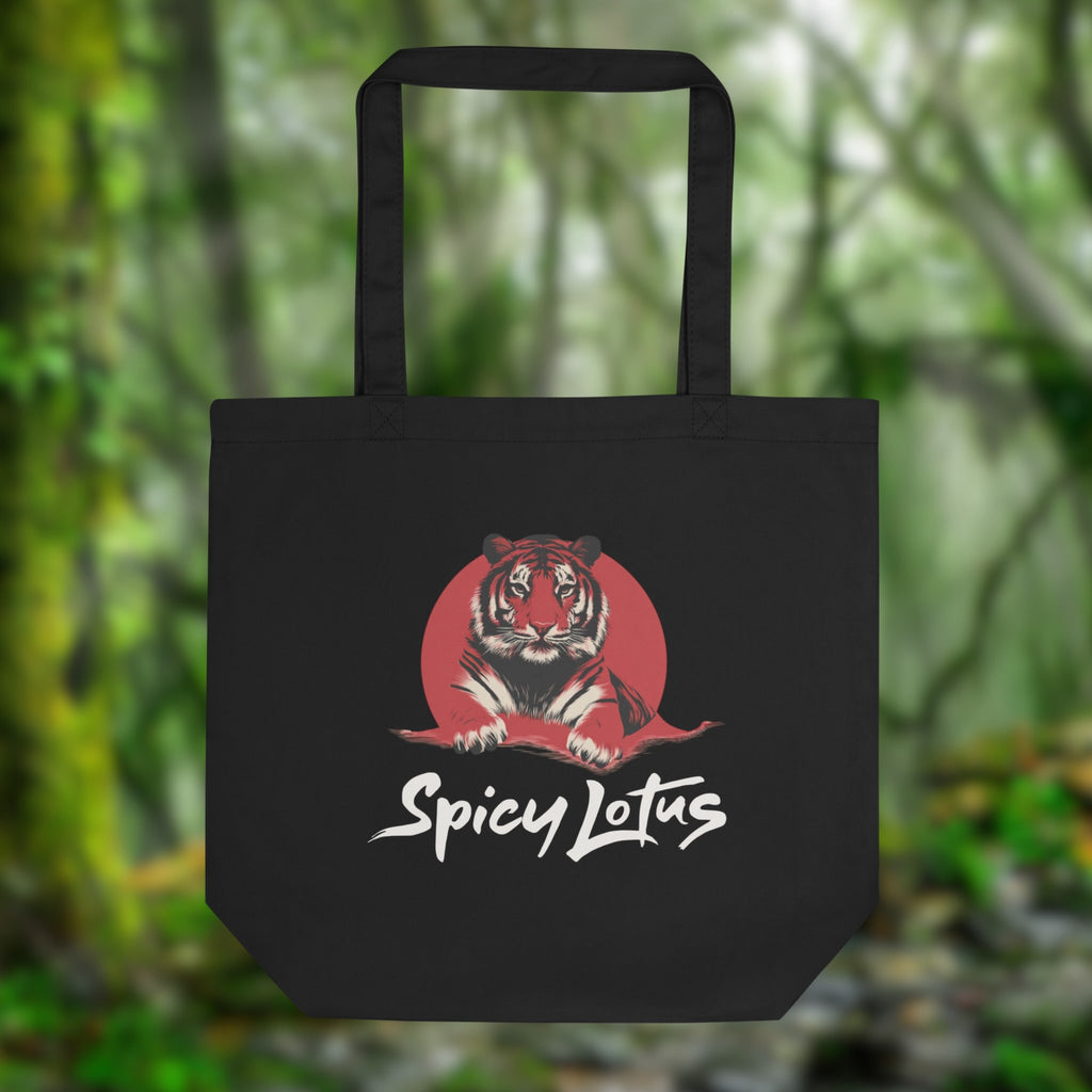 Black tote bag with a tiger design and 'Spicy Lotus' text against a blurred green forest background