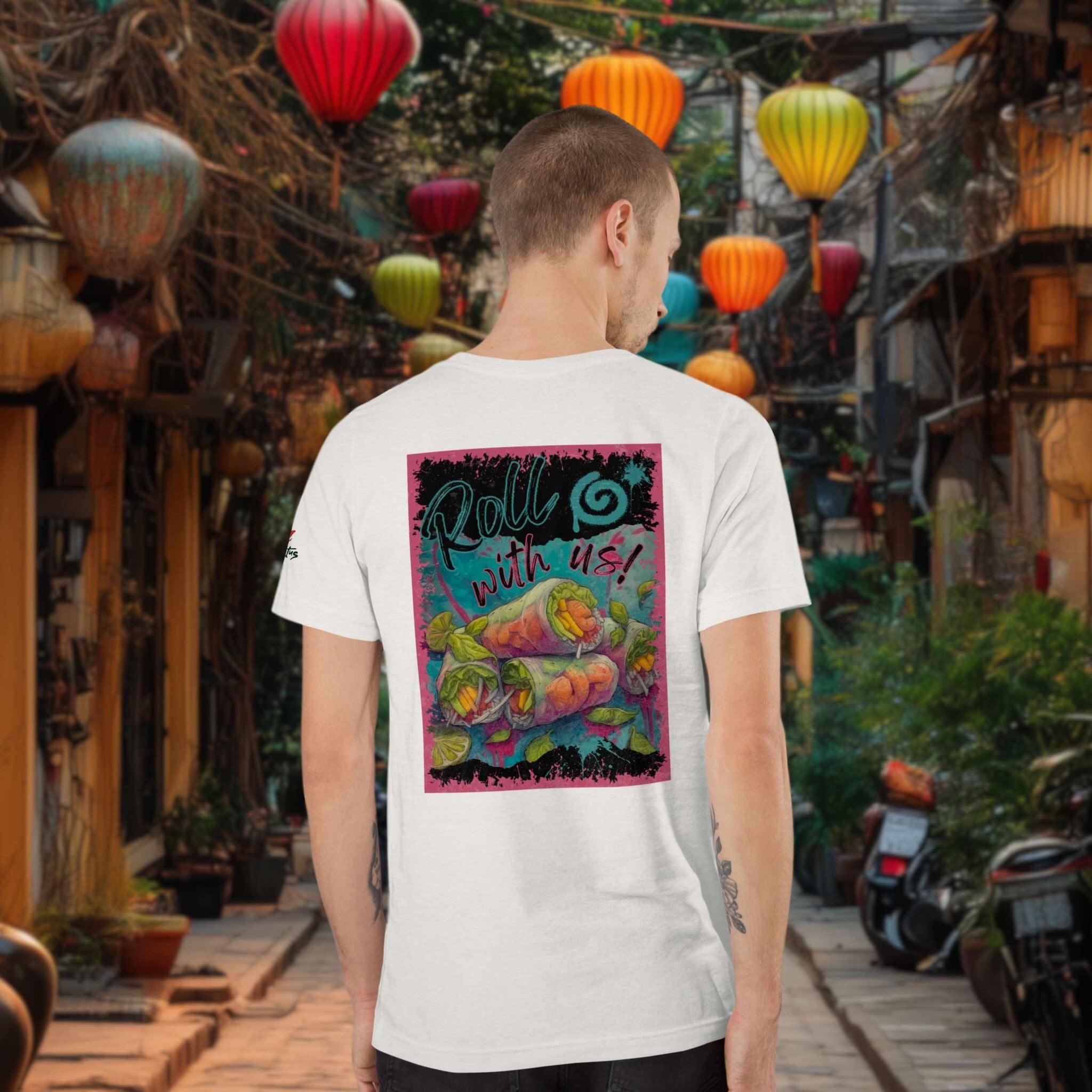 Person wearing a white t-shirt with a colorful graphic of vietnamese summer rolls on the back, standing in an outdoor setting with lanterns.