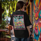 Woman wearing a black oversized  t-shirt with colorful graphic 'Roll with us' summer rolls design in an outdoor setting