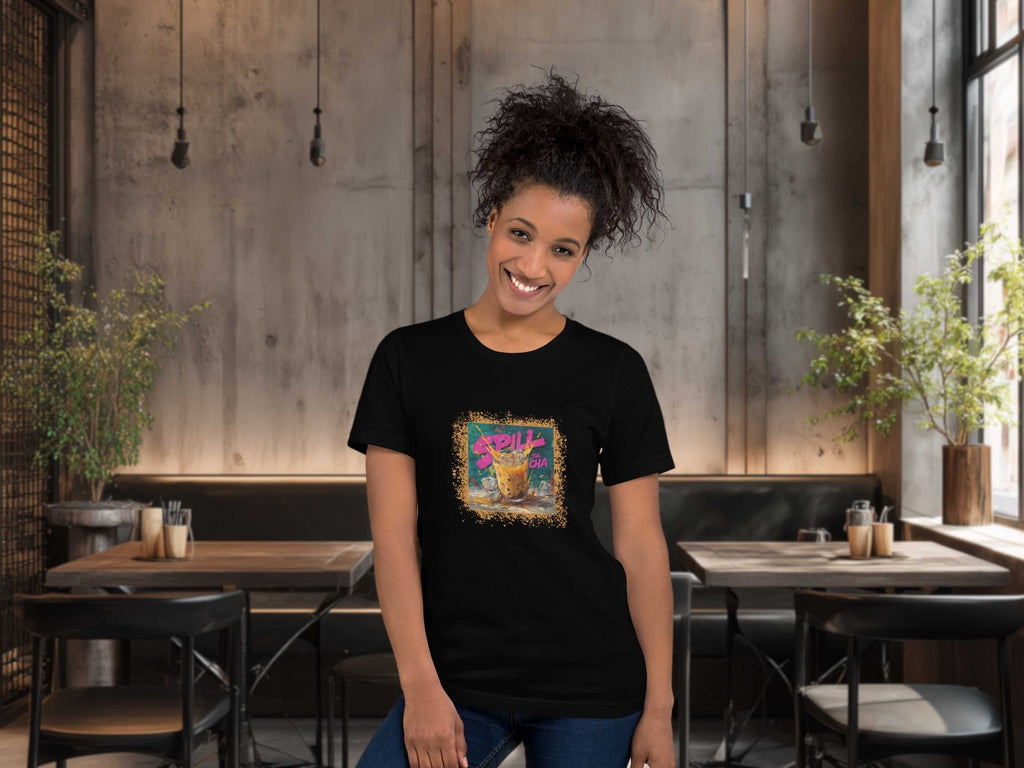 Woman wearing a black t-shirt with a colorful graphic design of thai milk tea graffiti style in a restaurant setting