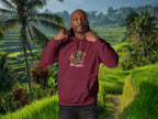 Person wearing a maroon hoodie with a logo in a tropical setting with rice terraces in Bali