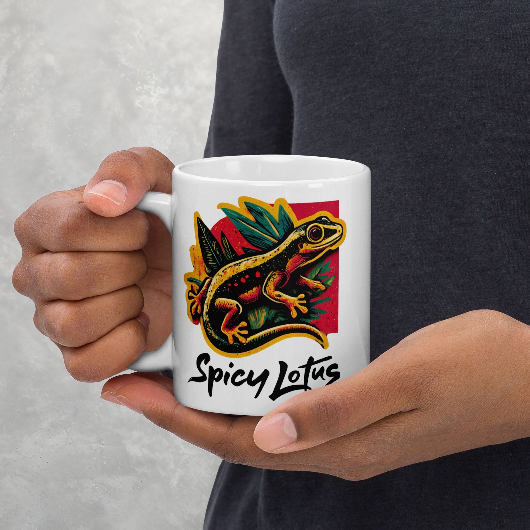 Person holding a white mug with a colorful gecko design and 'Spicy Lotus' text.