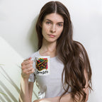 Woman holding a mug with a colorful design and text against a plain background