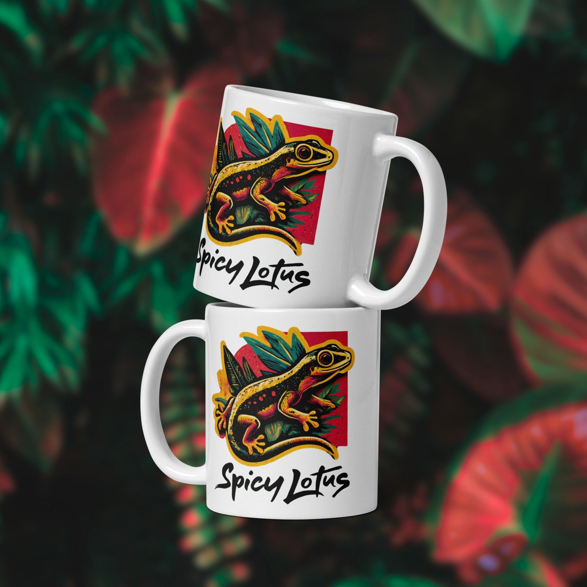 Two white mugs with a colorful gecko design and 'Spicy Lotus' text on a floral background.