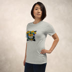 Person wearing a gray t-shirt with a colorful Stick With Me mango sticky rice street art t-shirt front print on a beige background