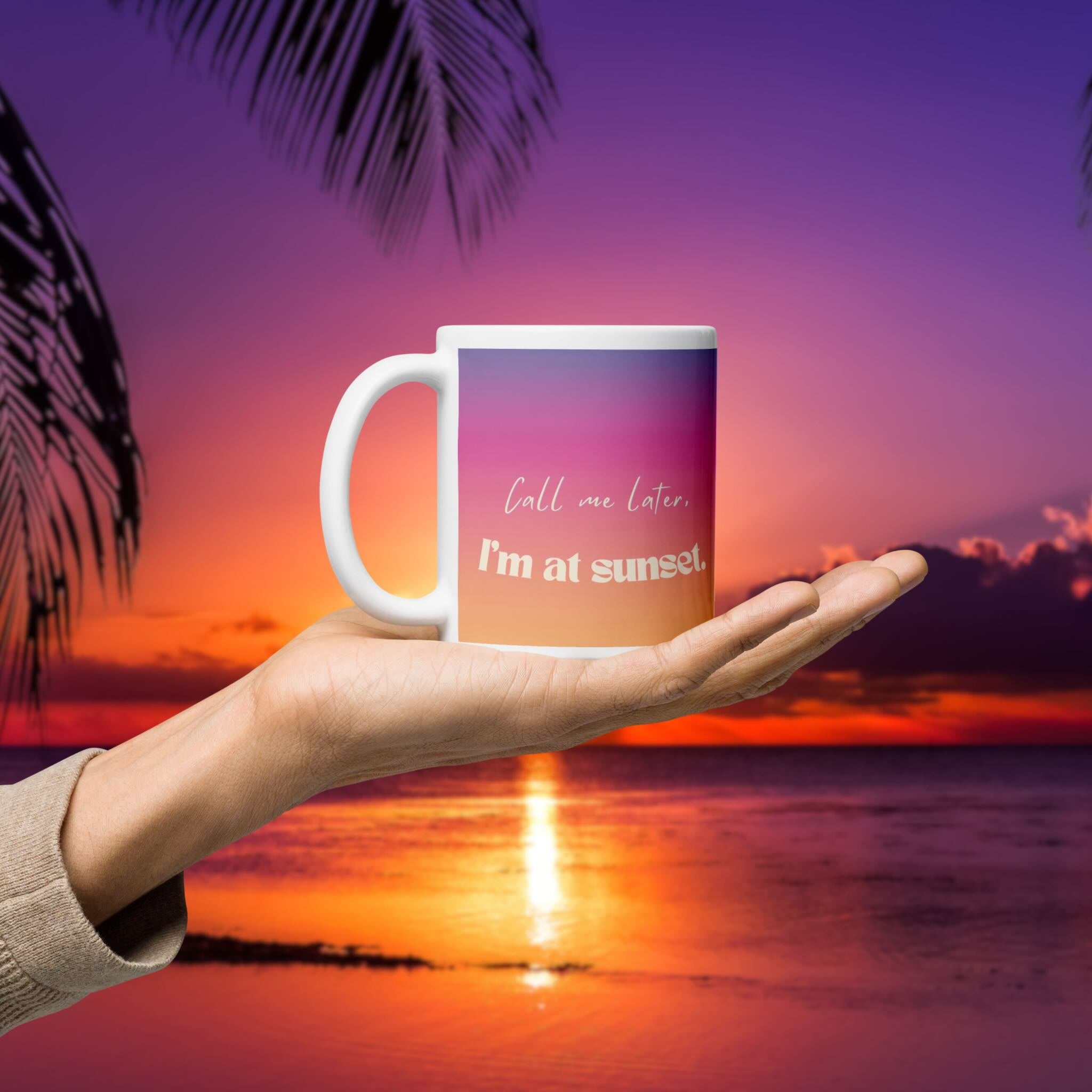 Mug with 'Call me later, I'm at sunset' text held against a sunset beach background