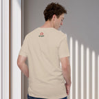 Man wearing a beige t-shirt with a Spicy Lotus logo on the back, standing against a neutral wall.