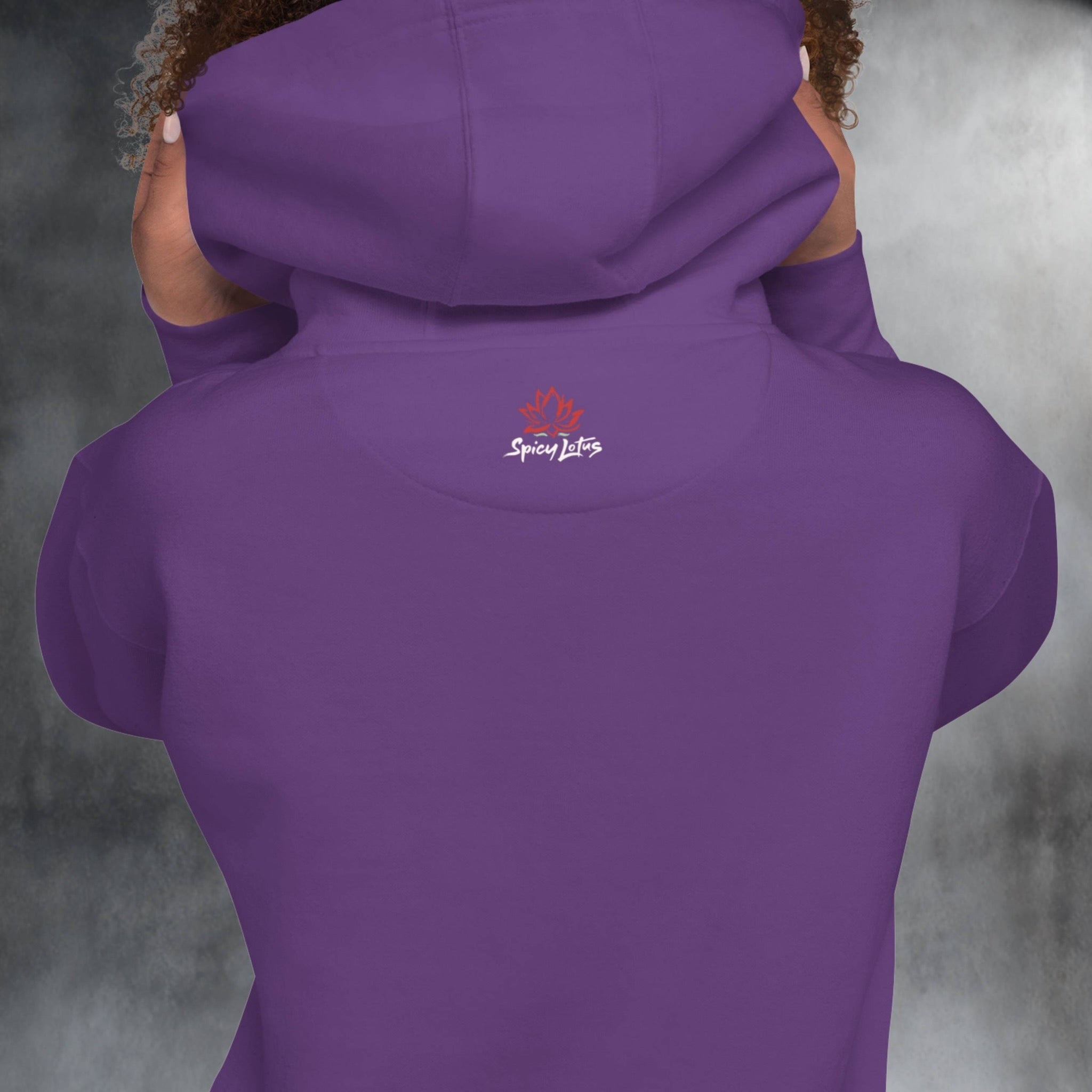 Purple hoodie with a logo on the back against a gray background