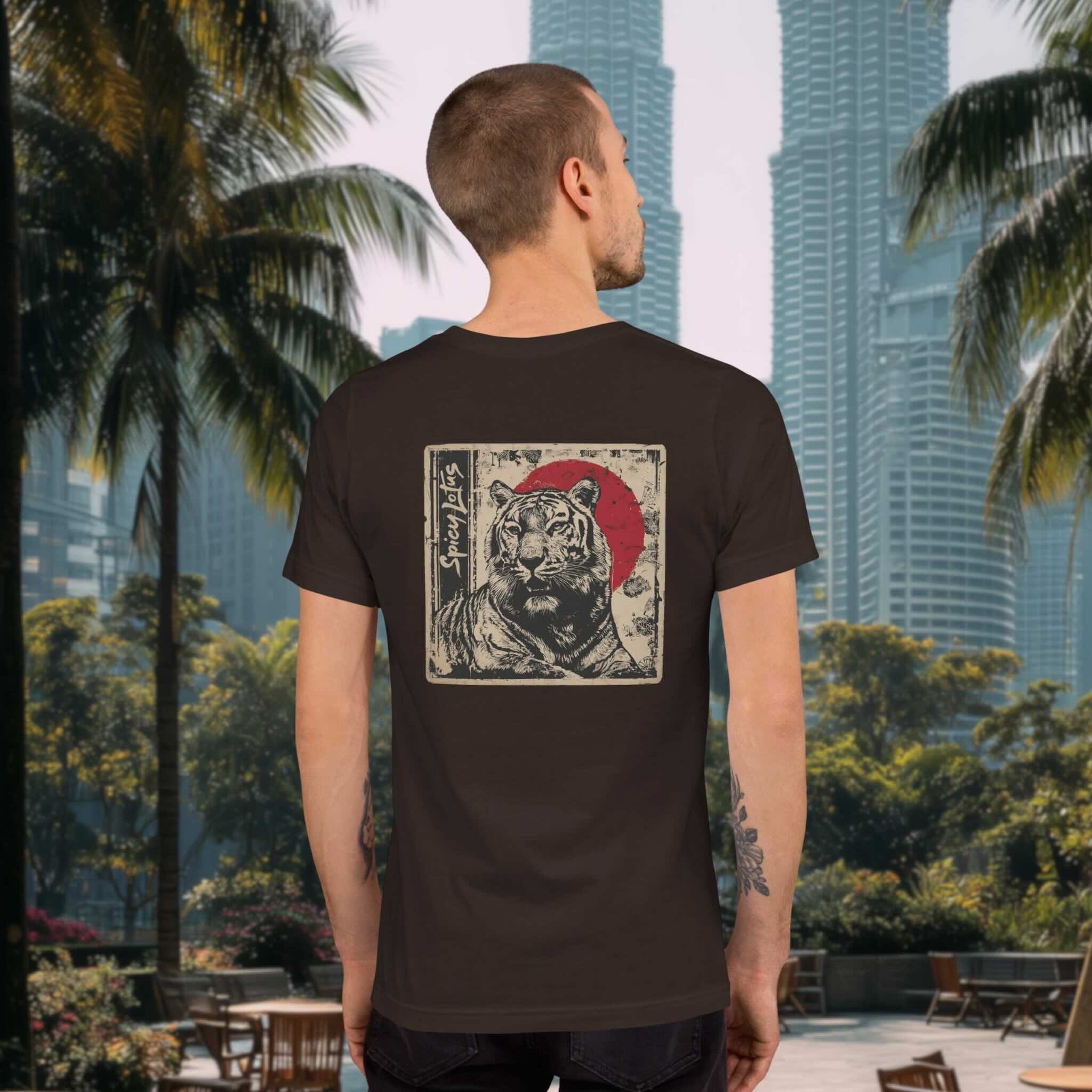 Man standing in front of the Petronas Towers in Kuala Lumpur wearing a Spicy Lotus Zen Tiger back print tee in brown