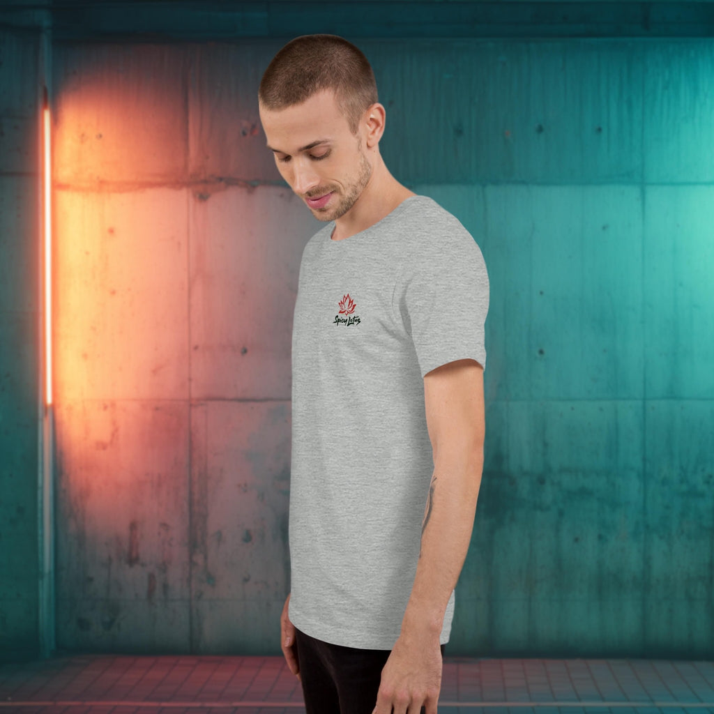 Man wearing a gray t-shirt with a logo against a colorful wall.
