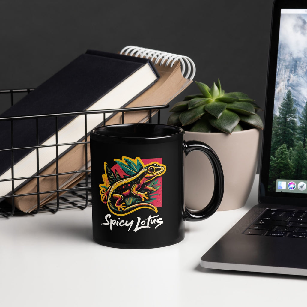 Black mug with colorful design and text 'Optimistic Nihilism' on a desk with laptop and books.