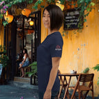 Vietnam jungle night surreal pop-art tee side view on a woman in standing in front of a vietnamese cafe with yellow walls