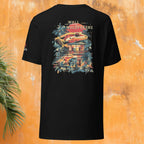 Black t-shirt with colorful gecko graphic design on the back against an orange wall.