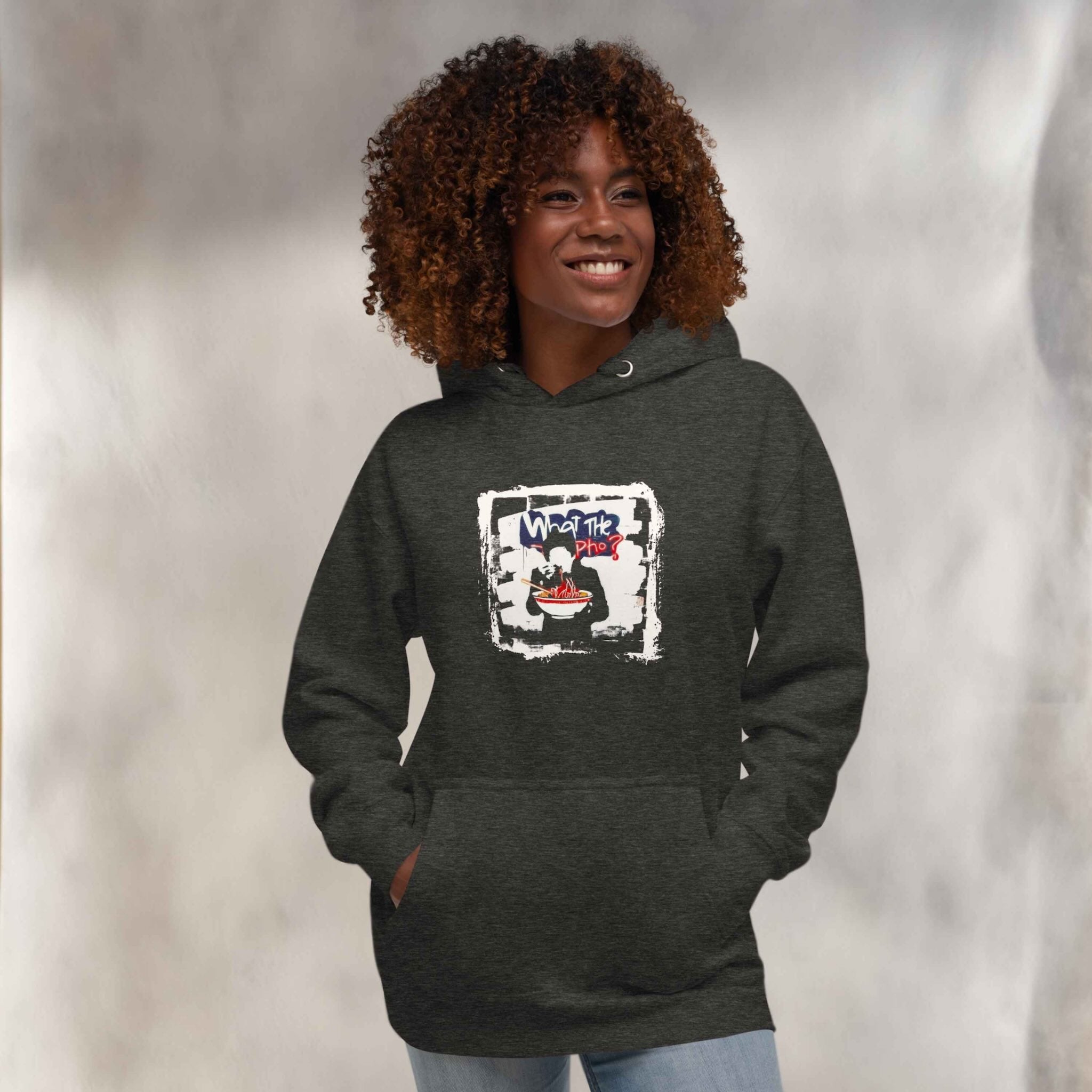 Person wearing a dark gray hoodie with a vietnamese pho graphic design, standing against a plain background.