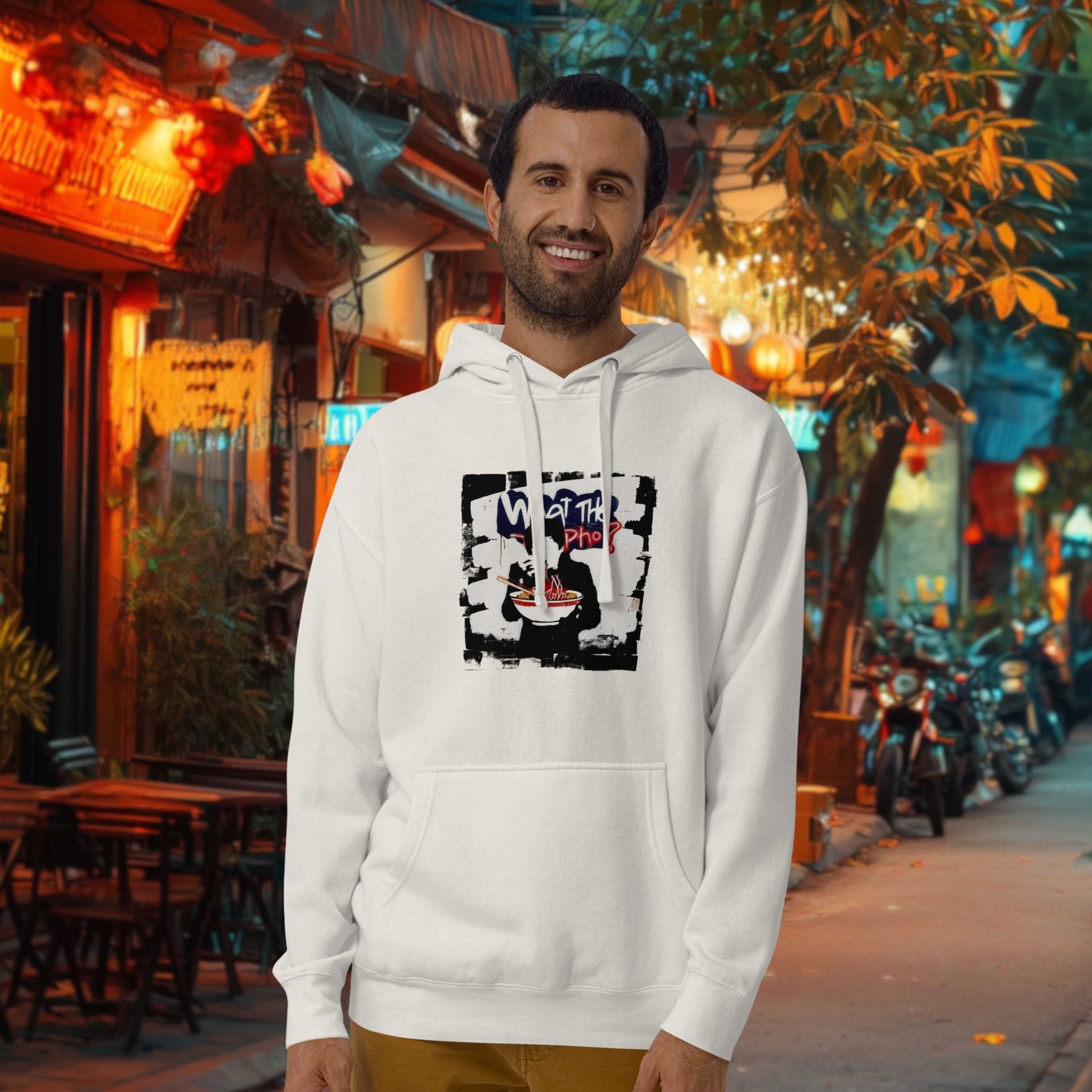 Model wearing What the Pho hoodie in urban Southeast Asia street setting