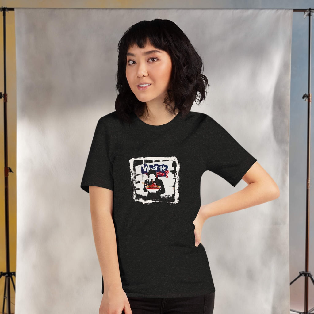 Person wearing a black t-shirt with a graphic design of 'what the pho?' against a neutral background